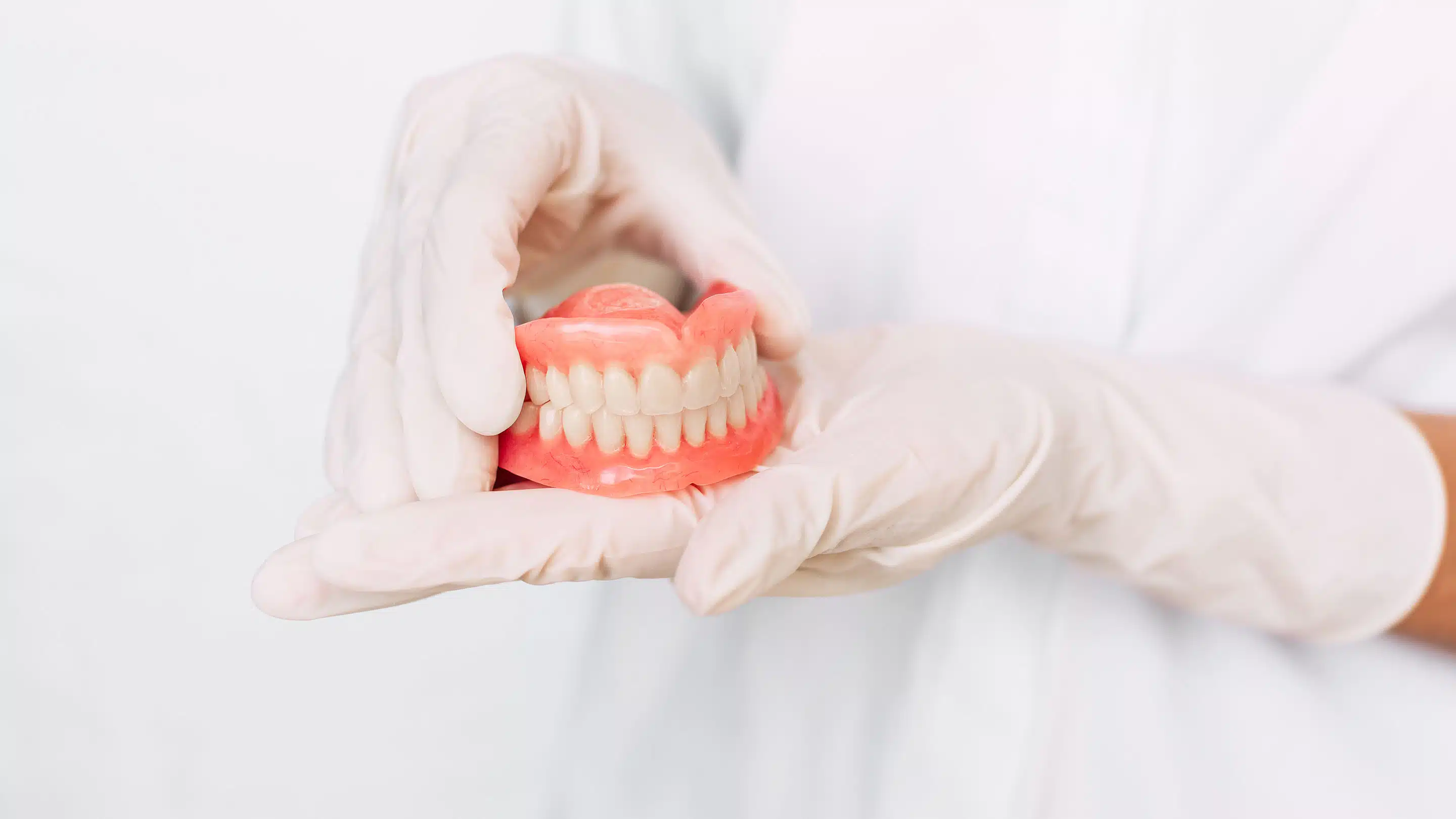 Dentist displaying a set of dentures