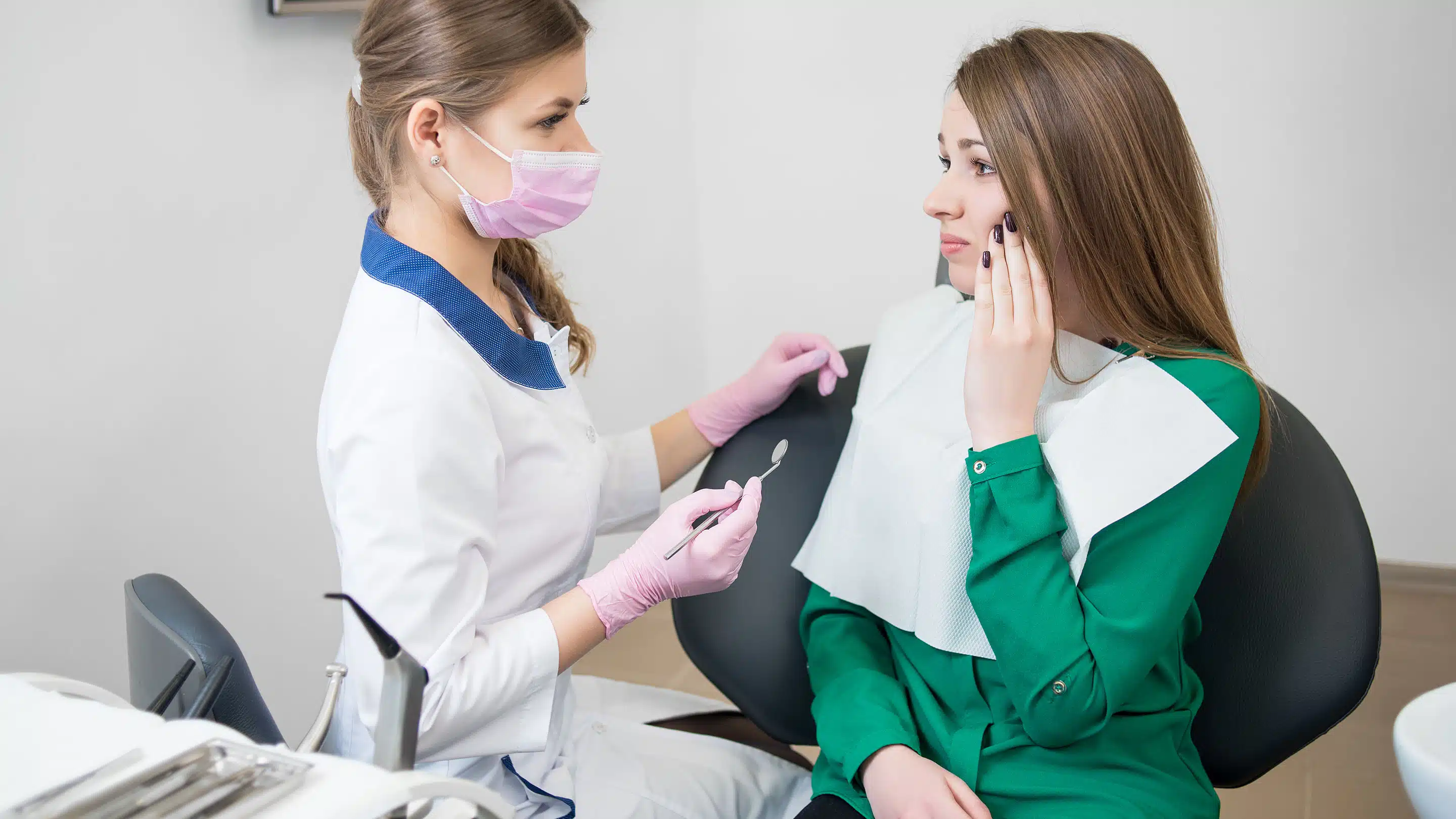 Dentist reassuring an anxious patient