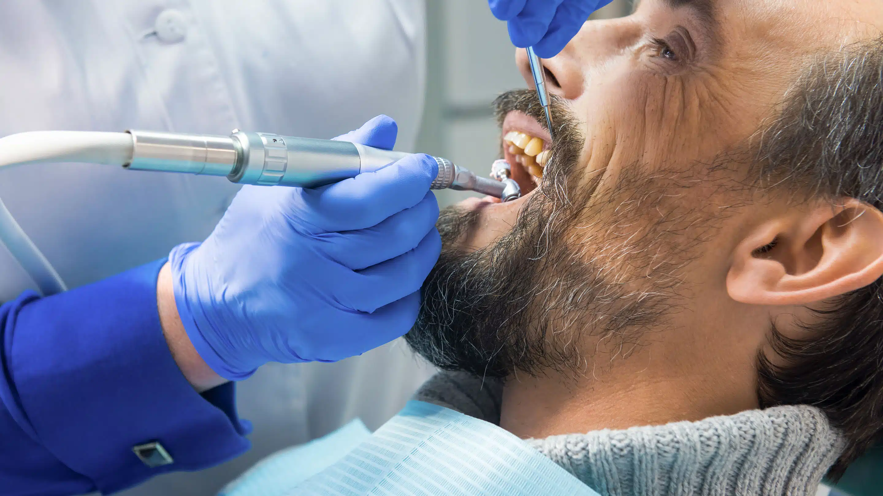 Dentist performing teeth cleaning procedure